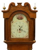 CIRCA 1900 LONGCASE CLOCK in oak having a painted dial with arched top, eight day movement by John