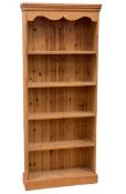 MODERN PINE BOOKCASE with five open shelves and shaped coving, 183cms H, 77cms W, 24cms D