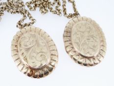 TWO SIMILAR 9CT GOLD OVAL LOCKETS, scroll engraved both with 9ct gold circle link chains, 98.7gms