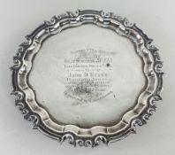 GEORGE V SILVER SALVER, scroll and point border raised on three scroll feet, presentation