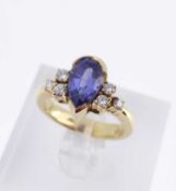 18K GOLD TANZANITE & DIAMOND RING, the central pear shaped tanzanite flanked by three diamonds