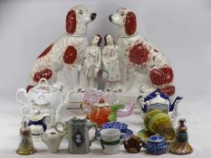 VICTORIAN STAFFORDSHIRE DOG FLATBACKS, a pair, red and white painted detail and modelled seated with