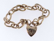9CT YELLOW GOLD OVAL LINK BRACELET, having heart shaped padlock, 18.3gms Provenance: private