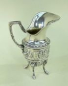 ARTHUR GRAF SILVER JUG, having exaggerated flared lip, repousse banded decoration, raised on four
