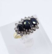 18CT GOLD SAPPHIRE & DIAMOND CLUSTER RING, the three central sapphires surrounded by sixteen