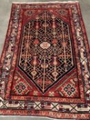 PERSIAN WOOLLEN RUG, red ground with inner white border and central large diamond, 130 x 200cms