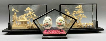 CASED CHINESE CORK WORK DIORAMAS, A PAIR - on lacquerwork stands and a pair of hand painted eggs