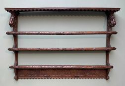 CONTINENTAL ANTIQUE OAK DELFT RACK, with animal mask uprights and leaf carved crossbars, 115cms wide