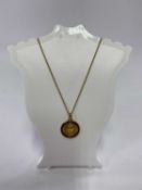 DIAMOND & RUBY SET CIRCULAR PENDANT on a nine carat gold fine link necklace, the pendant unmarked