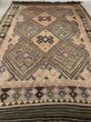 EASTERN WOOLLEN KELIM RUG with multi pattern border and diamond pattern throughout, 272 x 390cms