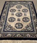 GOOD WOOLLEN RUG, blue ground with circular pattern central section, 124 x 186cms