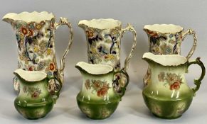 VINTAGE DECORATIVE JUGS - two sets of three in graduated sizes, the green trio stamped 'Rockingham