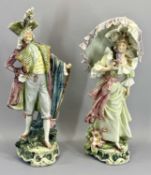 FRENCH FAIENCE FIGURES, A PAIR - depicting a lady with an umbrella and a gentleman, 54cms tall