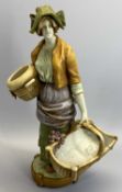 A CONTINENTAL FIGURE - lady carrying a basket on a circular base, marks indistinct, 44cms tall