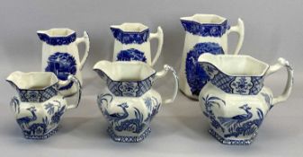 TWO SETS OF THREE BLUE & WHITE DECORATED GRADUATED JUGS - to include Wedgwood Etruria Landscape,
