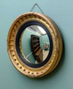 19TH CENTURY GILTWOOD & GESSO CONVEX MIRROR, with ebonised and reeded slip, 59cms diameter Comments: