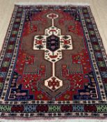 GOOD TURKISH WOOLEN RUG, in red and blue with central design, 179 x 130cms