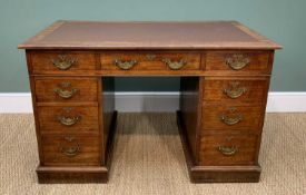 ANTIQUE KNEEHOLE WRITING DESK having a bank of nine drawers, bearing ornate brass handles and with