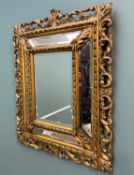 ANTIQUE GILTWOOD FIVE-PANE FURNISHING MIRROR, each section with bevelled glass, the openwork frame