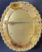 18CT GOLD PENDANT BROOCH - oval portrait format with rope twist edging, stamped '750', along with