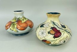 MOORCROFT POTTERY comprising two tube-lined squat vases, one decorated with apricots, dated 96