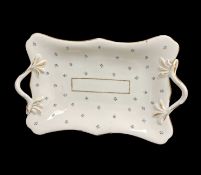 A SWANSEA PORCELAIN TWIG-HANDLED DISH of rounded and lobed rectangular form, decorated with