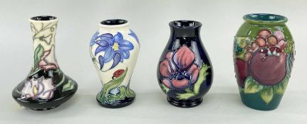 MOORCROFT POTTERY comprising four small tube-lined vases decorated with assorted flowers, birds