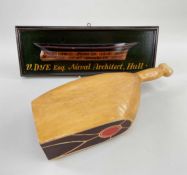 TWO WOODEN ADVERTISING PROPS being a butcher's ham-joint and a painted plaque with relief of a