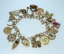 9CT GOLD CHARM BRACELET having 9ct gold heart padlock, sixteen 9ct gold charms including harp, speed