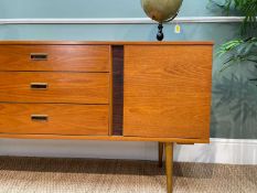 MID CENTURY TEAK & SIMILATED ROSEWOOD SIDEBOARD, fitted three drawers between cupboards, raised on