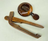 TWO TREEN NUTCRACKERS, comprising an 18th Century chip carved mortice nutcracker 14cms long, and a