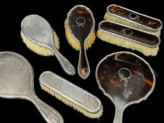 TWO SILVER PART DRESSING TABLE SETS, comprising 4-pc set George V tortoiseshell back mirror and