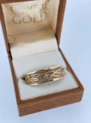 CLOGAU 9CT GOLD SCARF RING, set with three diamond chips, 10.1gms Provenance: Private collection