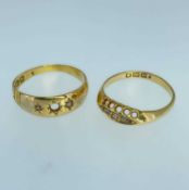 TWO 18CT GOLD RINGS comprising three stone diamond 'gypsy' set ring, together with five stone