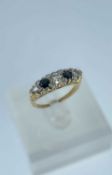 18CT GOLD FIVE STONE DIAMOND & SAPPHIRE RING, the central diamond measuring 0.25cts approx., ring