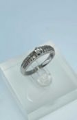 14K GOLD DIAMOND RING, the central stone measuring 0.2cts approx., set with a further 28 graduated