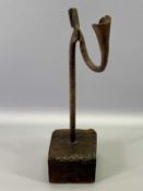 18TH CENTURY WROUGHT IRON NIP RUSH LIGHT HOLDER, square pine base, 35 cms high.