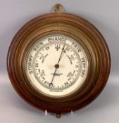 CIRCULAR BRASS CASED SHIP'S BULKHEAD BAROMETER, mounted on an oak board, John Baker & Co. Ltd.,