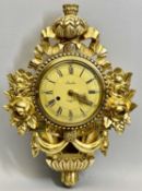A SKANDIA STOCKHOLM WALL CLOCK - in ornate gilt wood case decorated with flowers, ribbons and swags,