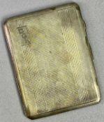 RECTANGULAR WHITE METAL CIGARETTE CASE - with engine turned decoration, monogrammed 'D G K', 11.5