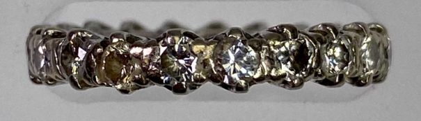 WHITE METAL ETERNITY RING - tested as 18ct white gold, claw set with 21 brilliant cut diamonds,