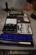 A selection of cased cutlery and flatware including cocktail spoons