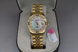 A gent's Ingersoll quartz dress watch having white stone set dial and bezel with gold plated strap
