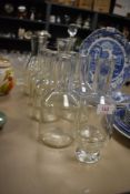 A selection of clear glass water bottles and similar