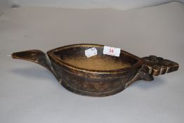 An antique Northern American tribal carved whale oil lamp filler