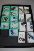 Nineteen pairs of fashion loop drop earrings of various forms including glass, mineral, hematite