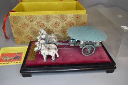 A model of a Chinese chariot and scroll