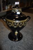 A late Victorian tea or similar ern or samovar having black ceramic body