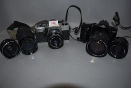 Two cameras. A Minolta Dynax 500si with Sigma 28-200mm zoom lens and Minolta 50mm and a Praktica