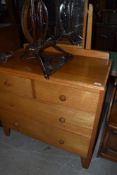 A 1950's golden oak dressing chest of two short and two lomg drawers on shaped feet, w 90cm
